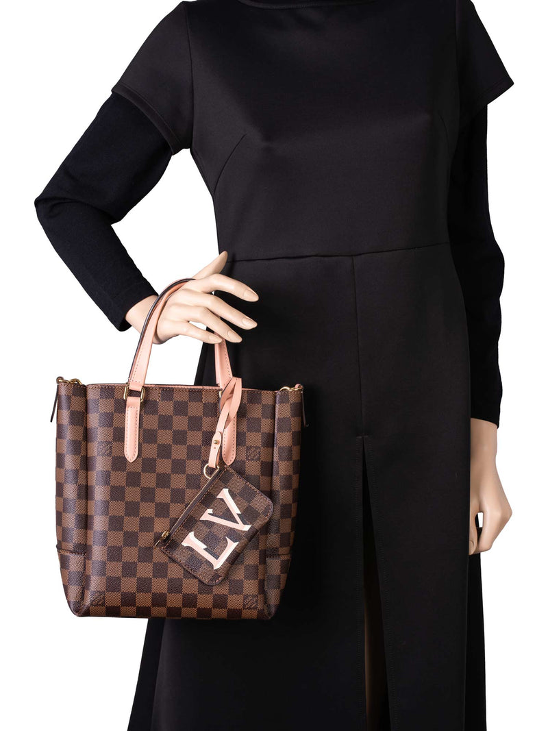 Woman with pink and brown Louis Vuitton bag and pink suit on