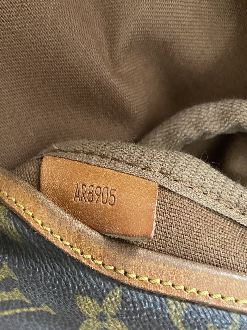 where is the serial number on a louis vuitton bag